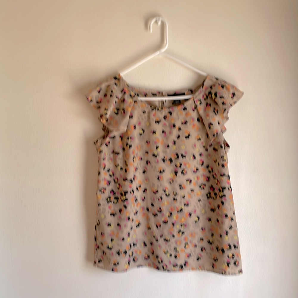 Go wild w/this flutter sleeve top with fun animal print. Style for day or night!
